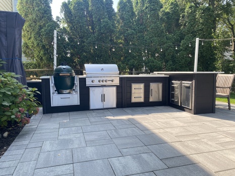 l shaped grill island with lots of storage and asado sleeve on patio with plank charcoal finish