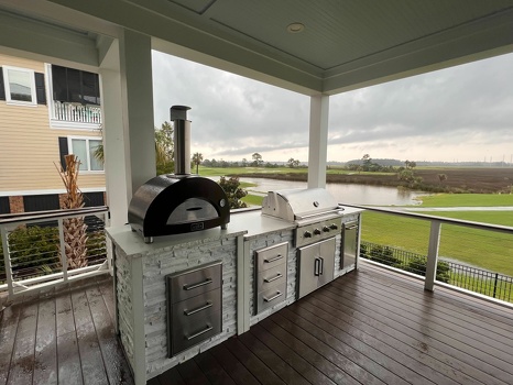linear grill island with pizza oven and storage drawers on deck in stacked stone chalk finish-1