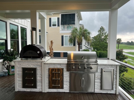 linear grill island with pizza oven and storage drawers on deck in stacked stone chalk finish-4