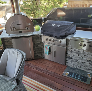 grill island with alfa 5 minuti and coyote grill cover on deck in stacked stone graphite finish-1