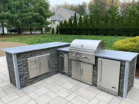 l shaped grill island with combo storage and regrigerator and pull out trash in stacked stone graphite-2