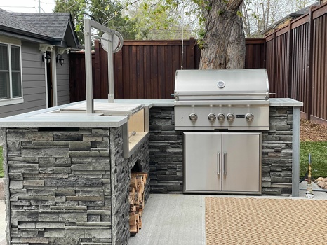 l shaped grill island with double access doors and argentine asado sleeve in stacked stone graphite-1