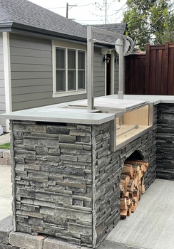 l shaped grill island with double access doors and argentine asado sleeve in stacked stone graphite-2