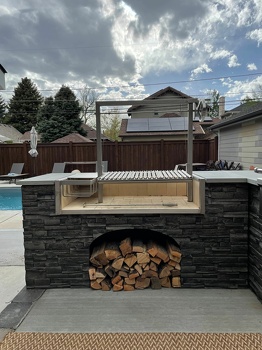 l shaped grill island with double access doors and argentine asado sleeve in stacked stone graphite-3