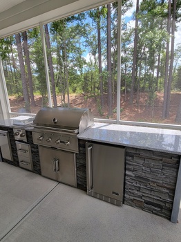 linear grill island with dual burner refrigerator and storage on patio in stacked stone graphite finish-1