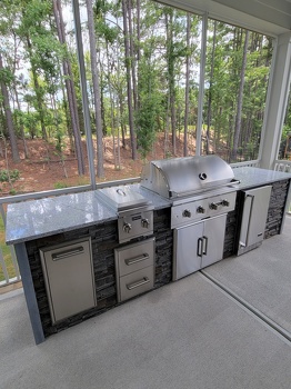 linear grill island with dual burner refrigerator and storage on patio in stacked stone graphite finish-2