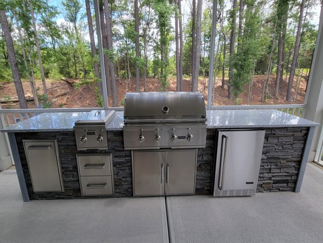 linear grill island with dual burner refrigerator and storage on patio in stacked stone graphite finish-3