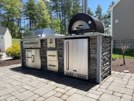 linear grill island with pizza oven combo storage and refrigerator on patio in stacked stone graphite finish-3