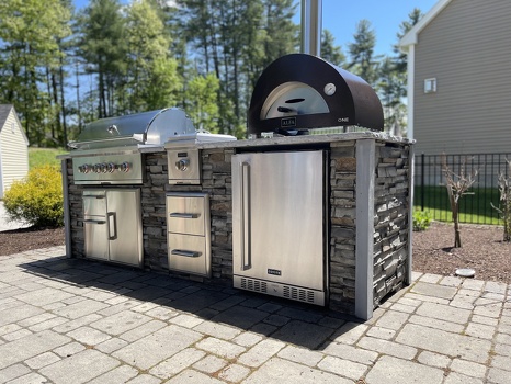 linear grill island with pizza oven combo storage and refrigerator on patio in stacked stone graphite finish-5