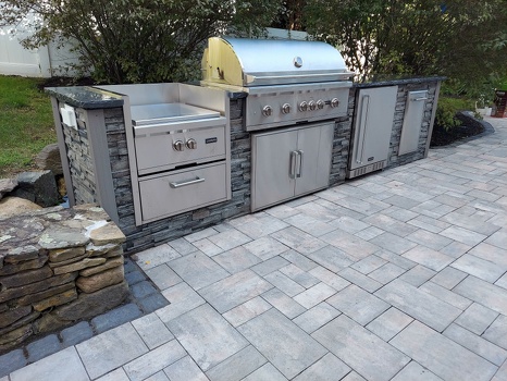 linear grill island with power burner and refrigerator on patio in stacked stone graphite finish-3