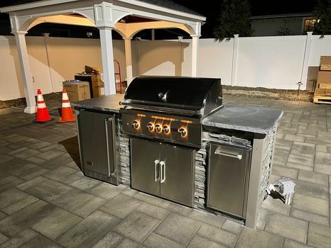linear grill island with refrigerator and pull out trash on patio in stacked stone graphite finish-2