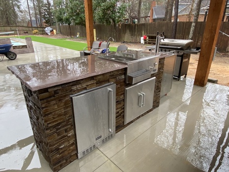 galley style outdoor kitchen with combo storage refreshment center and storage on patio under gazebo in stacked stone terra finish-3